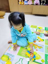 High angle view of girl playing with toy