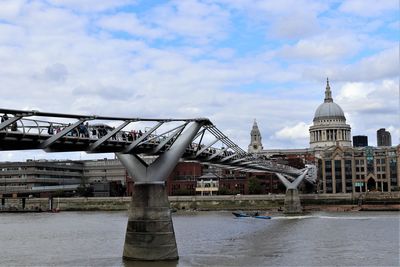 View of bridge over river against cloudy sky