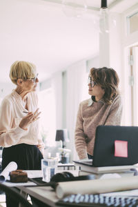 Two women having a discussion working at home