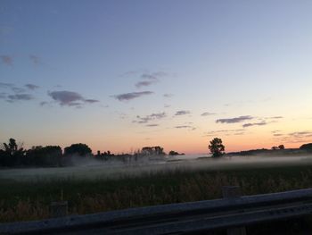 Scenic view of field against sky during sunset