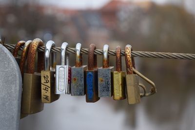 Close-up of padlocks hanging on steel cable