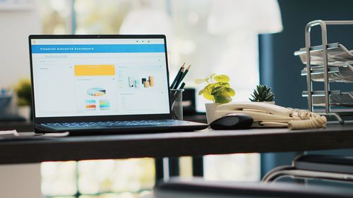 Midsection of woman using laptop on table