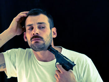 Portrait of mature man against black background