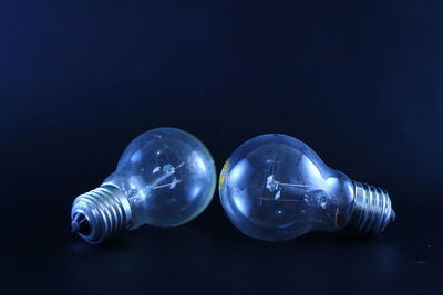 Close-up of light bulb against black background