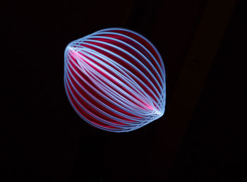 Close-up of illuminated lighting equipment against black background