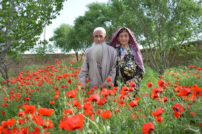 Woman standing by flowering plants