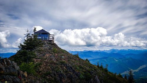 Built structure on building by mountains against sky