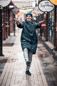 Full length portrait of young man in snow