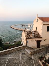 High angle view of building by sea against sky