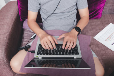 High angle view of woman using laptop on table