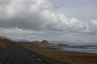 Road by sea against sky