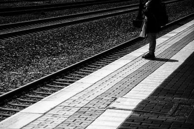 Low section of person standing on railway station platform