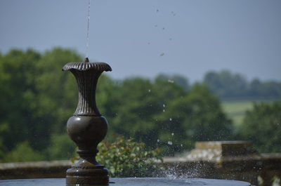 Close-up of water fountain against sky