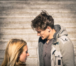 Close-up of couple against wall