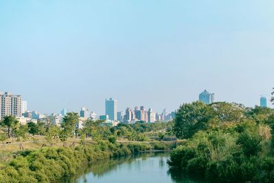 View of calm river with buildings in background