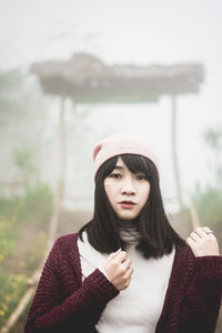 Portrait of beautiful young woman standing outdoors