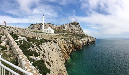 Panoramic view of sea and buildings against sky