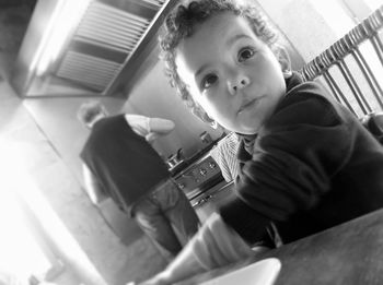 High angle view of boy photographing while sitting at home