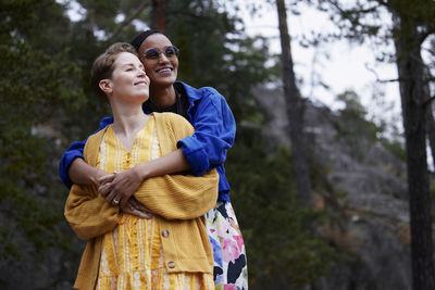 Female couple hugging outdoors