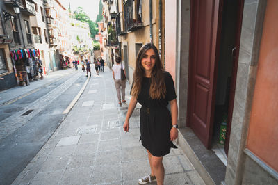 Portrait of woman standing in city