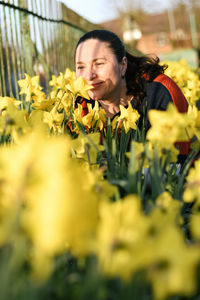 Woman on yellow flowering plants