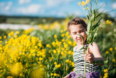 Portrait of boy on yellow flower field
