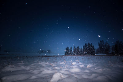 A beautiful, dark winter scenery while snowing. bright white snowflakes.