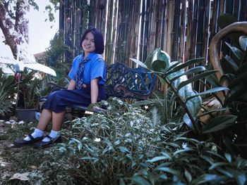 Portrait of smiling girl sitting on plants