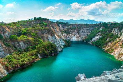 High angle view of lake amidst mountains against sky