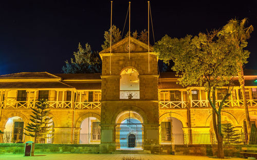 Illuminated building against sky at night