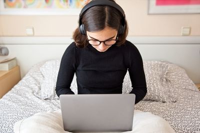 Midsection of woman using mobile phone at home