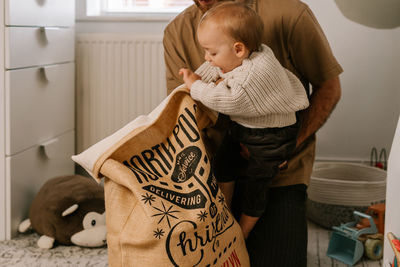 Side view of woman holding teddy bear