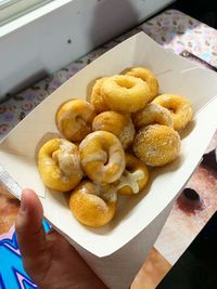 High angle view of hand holding food on table