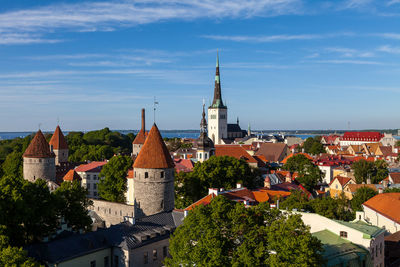 High angle view of bell tower in city against sky