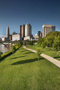 View of city buildings against clear sky