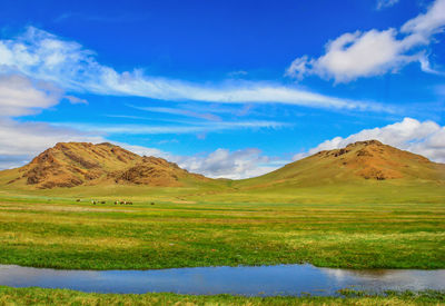 Scenic view of landscape and mountains against sky