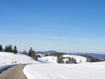 Snow covered landscape against sky