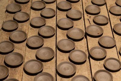 High angle view of clay plates on table