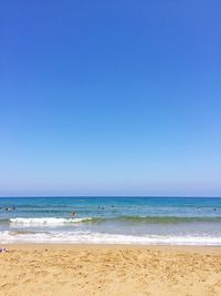 Scenic view of beach against clear blue sky