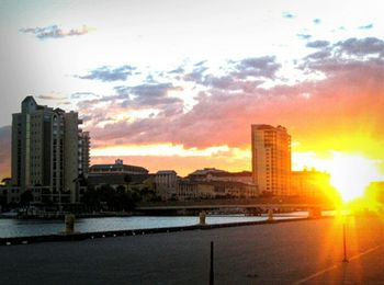 Skyscrapers in city at sunset