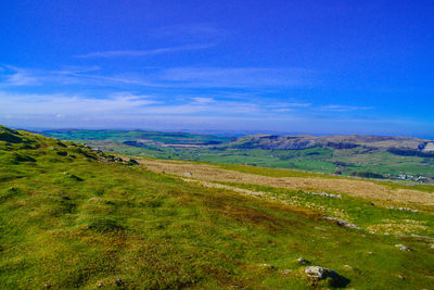 Scenic view of landscape against blue sky