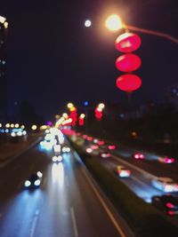 Close-up of illuminated cars on road at night