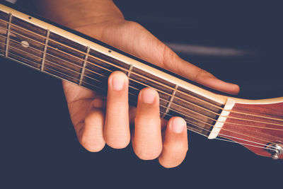 High angle view of hand playing guitar