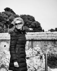 Woman standing on tree trunk