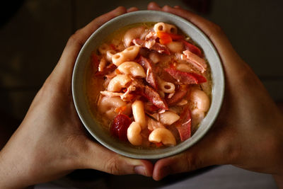 High angle view of person holding soup