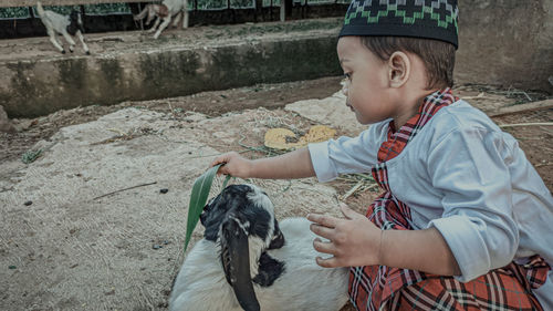 A child's side appearance with a goat