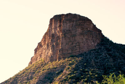 Low angle view of rock formation against clear sky