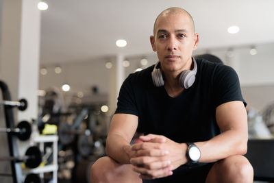Portrait of young man exercising at gym