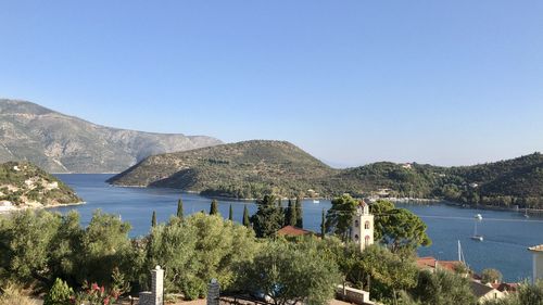 Panoramic view of lake and mountains against clear blue sky