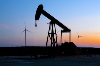 Pump jack in motion on a wind farm in ft. davis, texas